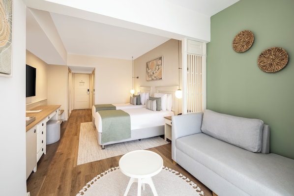 A modern bedroom with a bed, bedside tables, a sofa, and a small round table. - Mirada Exclusive Bodrum (Bodrum)