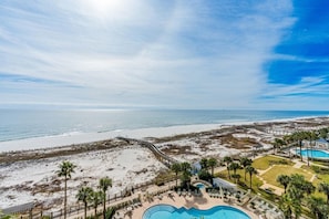 A resort with a swimming pool, beach access, and a view of the ocean.