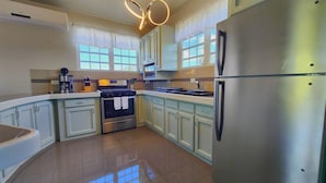 A modern kitchen with a stainless steel refrigerator, a built-in oven, and a coffee maker. - 2 units | Sleeps 12 | Beach | Pool | Sunsets | Fun (Aguada)