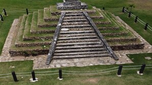 A pyramid-like structure with a central staircase surrounded by stone steps.