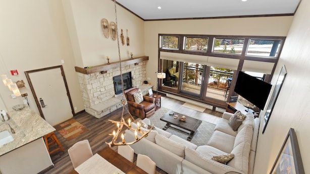 A spacious living area with a fireplace, large windows, and a dining area. - Mountain & Golf Course Views, & Minutes to Ski Lifts! PET FRIENDLY! (Keystone)