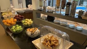 A buffet with various food items including fruits, pastries, and beverages. - Sikamifer Tourist Resort (Quatre Bornes)