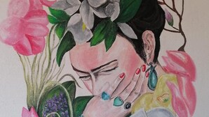 Una pared con un cuadro de una mujer rodeada de flores.