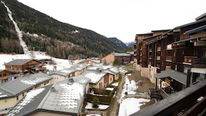 Ein Bergdorf mit Holzhäusern und schneebedeckten Dächern.
