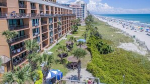 A hotel with multiple balconies overlooking a beach. - Ocean front - 6th Floor Caravelle Resort (Myrtle Beach)