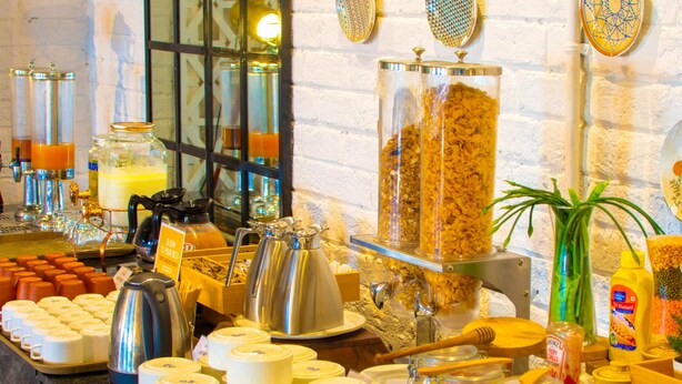 A buffet with various food items and condiments. - Bloom Hotel - Gachibowli (Hyderabad)