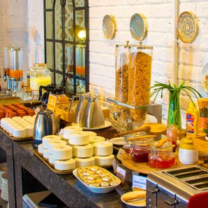 A buffet with various food items and condiments. - Bloom Hotel - Gachibowli (Hyderabad)
