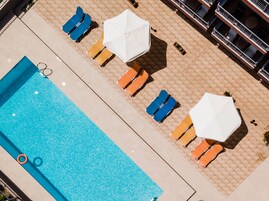 Seasonal outdoor pool, open 8:00 AM to 8:00 PM, pool umbrellas