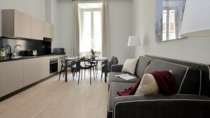 A modern apartment with a kitchen, dining area, and living room. - Monti Apartments - M5 (Rome)