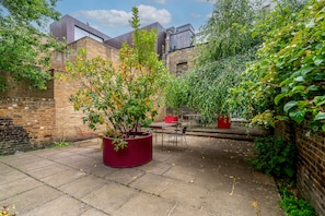Relax in the serene courtyard, surrounded by lush greenery and a tranquil atmosphere.