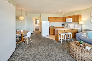 A compact living space with a kitchenette, a dining area, and a seating area.