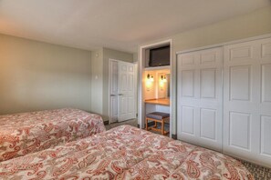 A hotel room with two beds, a TV, and a seating area with a table and chairs. - Beachfront Family Suite - Ocean View - Full Kitchen (Lincoln City)