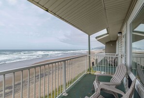 A balcony with a view of the beach and ocean. - Beachfront Suite with Ocean View, Full Kitchen, Pool & Hot Tub Access! (Lincoln City)