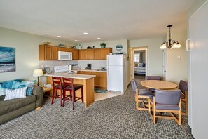 A compact living space with a kitchenette, a dining area, and a seating area.