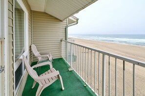A balcony with a view of the beach, two chairs, and a railing. - Top Floor Family Suite with Fireplace and Kitchen - Beach Access - Beautiful Ocean Views! (Lincoln City)