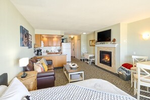 A hotel room with a bed, a sofa, a dining table, a fireplace, and a kitchenette. - Amazing Ocean View Suite - Sleeps Six - Pool Access & Hot Tub! (Lincoln City)
