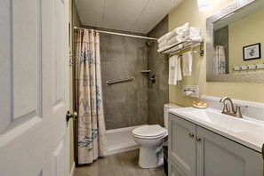 A bathroom with a shower, toilet, and sink. - Ocean View Suite - Sleeps Six - Heated Indoor Pool & Hot Tub Access (Lincoln City)