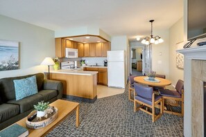 A compact living space with a kitchenette, a dining area, and a seating area.