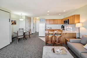 A compact hotel room with a kitchenette, a dining area, and a living space. - King Suite - Oceanfront Balcony & Central Location - Pool & Hot Tub! (Lincoln City)