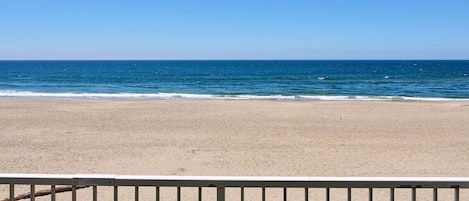 A beach with a clear sky and calm sea.