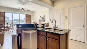 A modern kitchen with a large island, stainless steel appliances, and a view of the city. - Stunning Waterfront Penthouse with Rooftop Casita – Steps to Clearwater Beach (Clearwater)