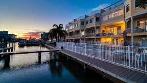 A waterfront hotel with a dock, multiple balconies, and a pool area. - Stunning Waterfront Penthouse with Rooftop Casita – Steps to Clearwater Beach (Clearwater)