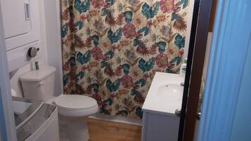 Bathtub, hair dryer, towels, soap