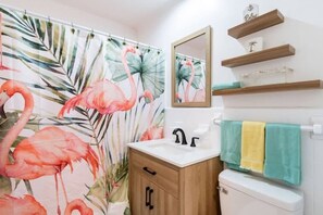 Bathtub, hair dryer, towels, shampoo