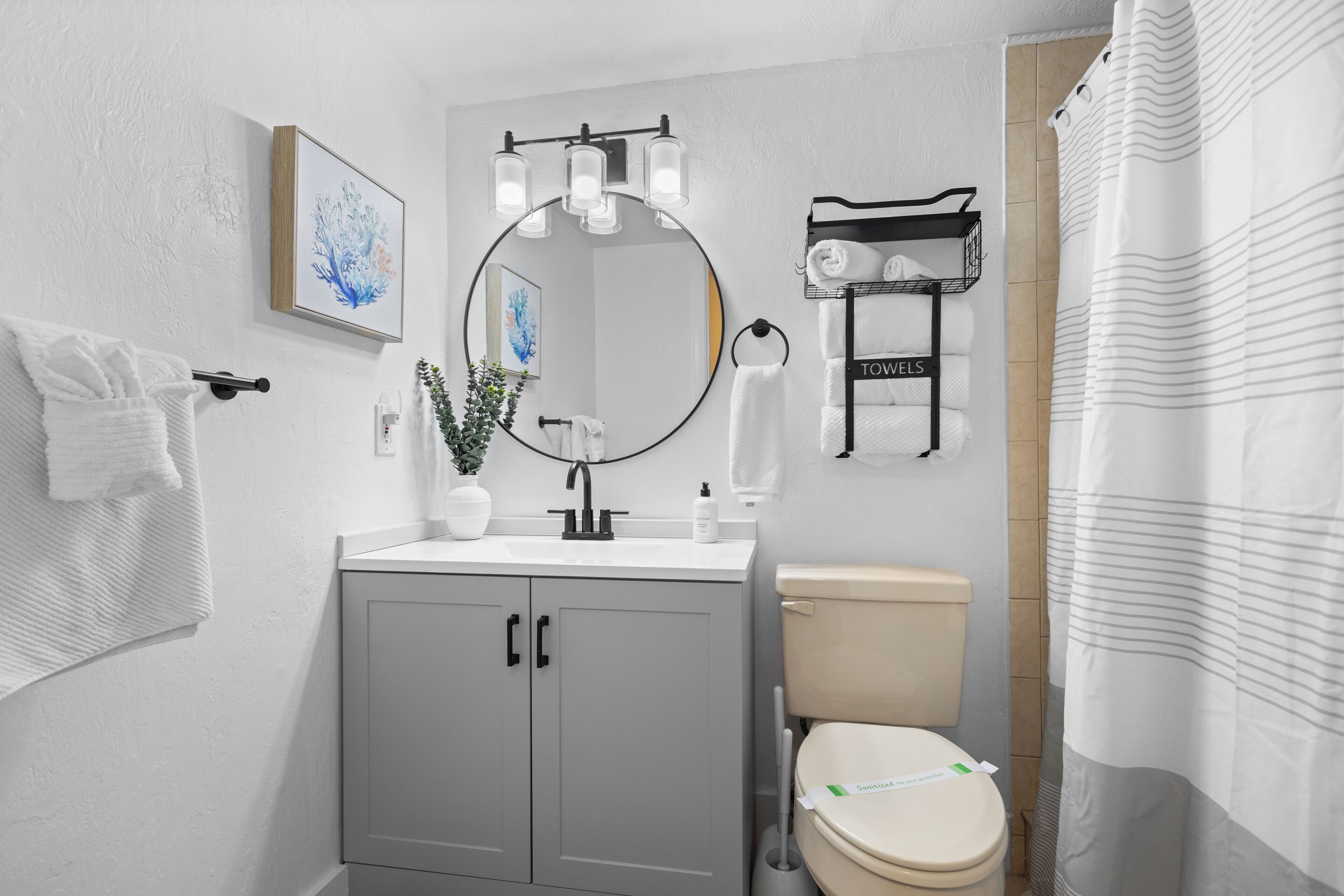 A modern bathroom with a toilet, sink, and towel rack.