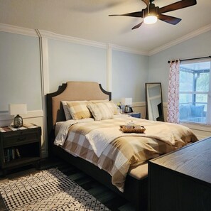 A neatly arranged bedroom with a bed, bedside table, and a ceiling fan. - Pool, pool table, 4 bedroom, 2.5 bath home with very high rating! (Brandon)