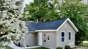 A single-story house with a gabled roof, a front door, and a small porch area. - Cute tiny home with everything you need! (Cedar Falls)