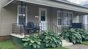 A single-story house with a covered porch, a mailbox, and a number sign. - Cheerful 3 bedroom, 2 bath home. (Nelsonville)