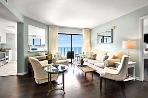 A spacious living room with a balcony, a dining area, and a kitchen. - Superb oceanfront condo w/pool, sundeck, private balcony near pier for fishing, walking, crabbing (North Myrtle Beach)