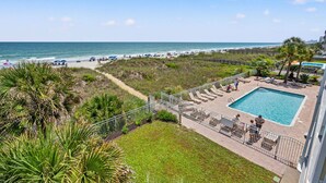 A pool area with a view of the beach and ocean. - Fantastic, budget-friendly option for your next beach vacation (North Myrtle Beach)
