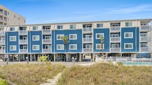 A beachfront hotel with multiple-story buildings, outdoor pools, and a sandy walkway. - Your Classic Oceanfront Retreat in North Myrtle Beach! (North Myrtle Beach)
