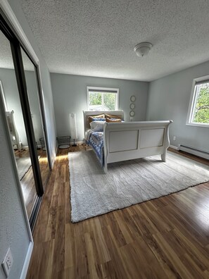 A bedroom with a bed, a window, and a door. - 3 Bedroom-Queen Beds-UMed-Stunning Mountain Views-Trails to lakes (Anchorage)
