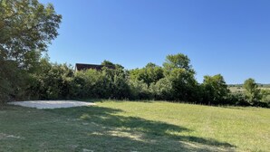 A grassy field with trees and a building in the background. - Country house near Cabreret (Orniac)