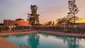 A rectangular swimming pool with a metal ladder on the left side, surrounded by a metal fence. - Rejuvenating Retreat w/ Ideal Eloy Location! (Eloy)