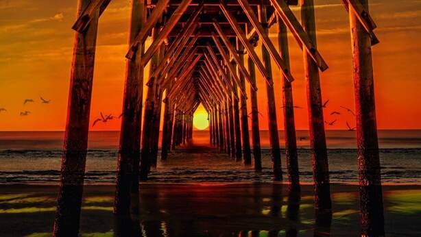 A pier leading to a sunset over the ocean. - Ocean Isle Beach Getaway Is A Slice Of Heaven (Ocean Isle Beach)