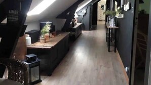 A modern kitchen with a central island, dark walls, and a sloped ceiling with skylight. - Magnificent residence with heated indoor pool (Guipry-Messac)