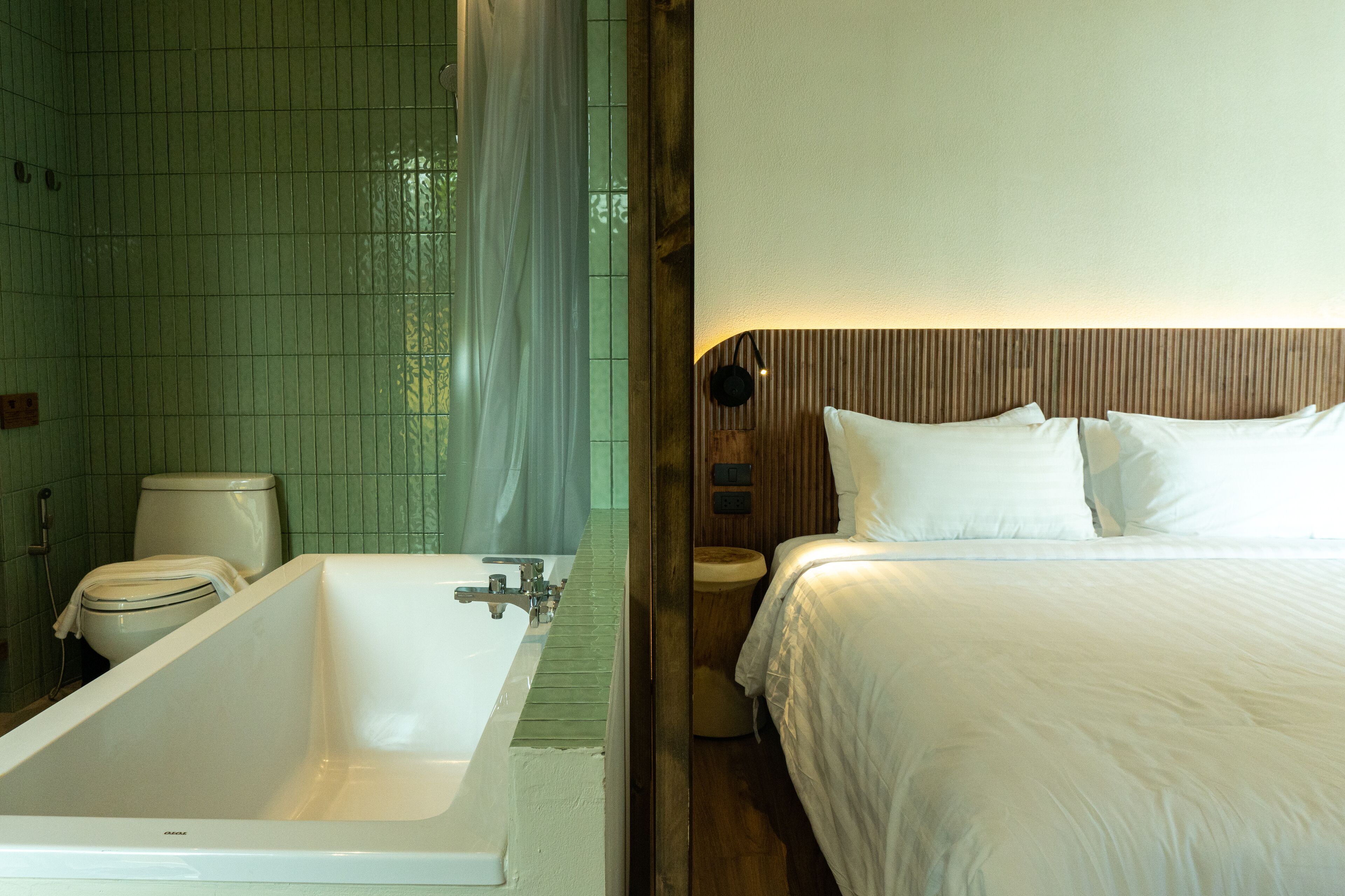 A bathroom with a bathtub, toilet, and shower area.
