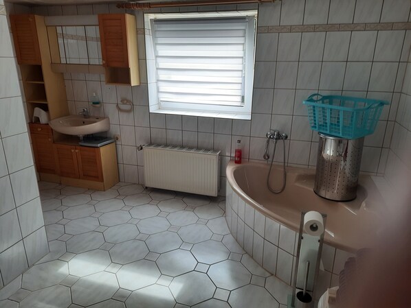 Bathtub, hair dryer, towels, soap