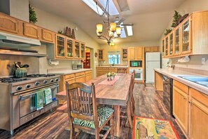 Enjoy cooking in this well-equipped kitchen with a central island, sink, and stainless steel appliances.
