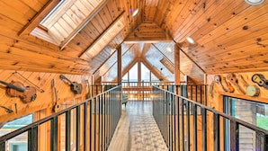 A wooden interior with a central staircase, wooden beams, and a view through a window. - Lakefront Applegate Retreat w/ Private Beach! (Applegate)