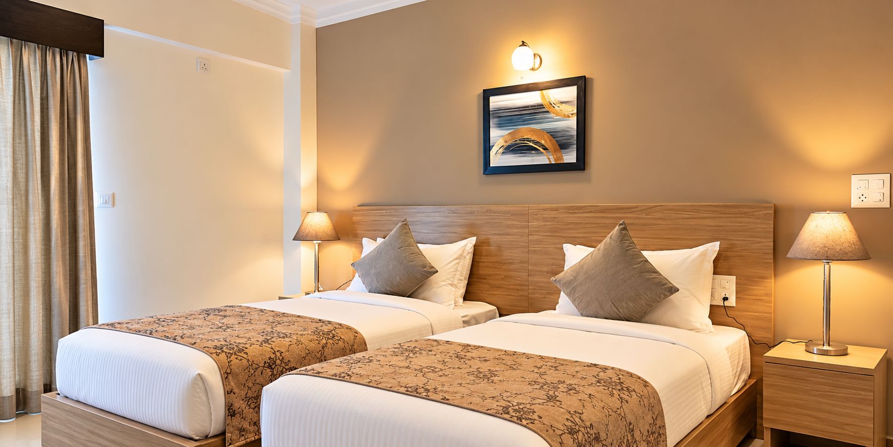 A hotel room with two beds, a headboard, bedside lamps, a wall-mounted light, and a painting.