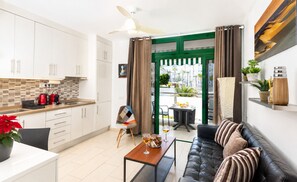 A modern apartment with a kitchen, dining area, and living room.