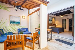 A modern interior with a seating area, a bed, and a view of the outside.