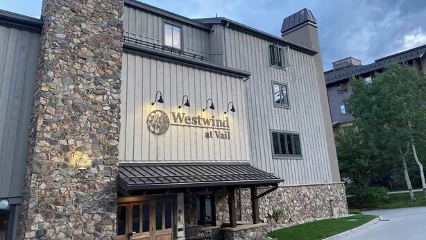 A building with a stone facade and a sign that reads "Westwind at Vail." - Great Condo just 3 min walk to Lionshead Gondola. (Vail)