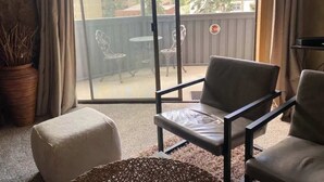 A balcony with a view of mountains, a table, and two chairs. - Great Condo just 3 min walk to Lionshead Gondola. (Vail)