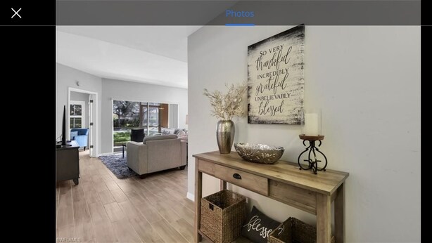 A modern living room with a sofa, a coffee table, and a decorative wall piece. - Cozy Condo on Golf Course/Summer Rental/ Fort Myers  (Fort Myers)